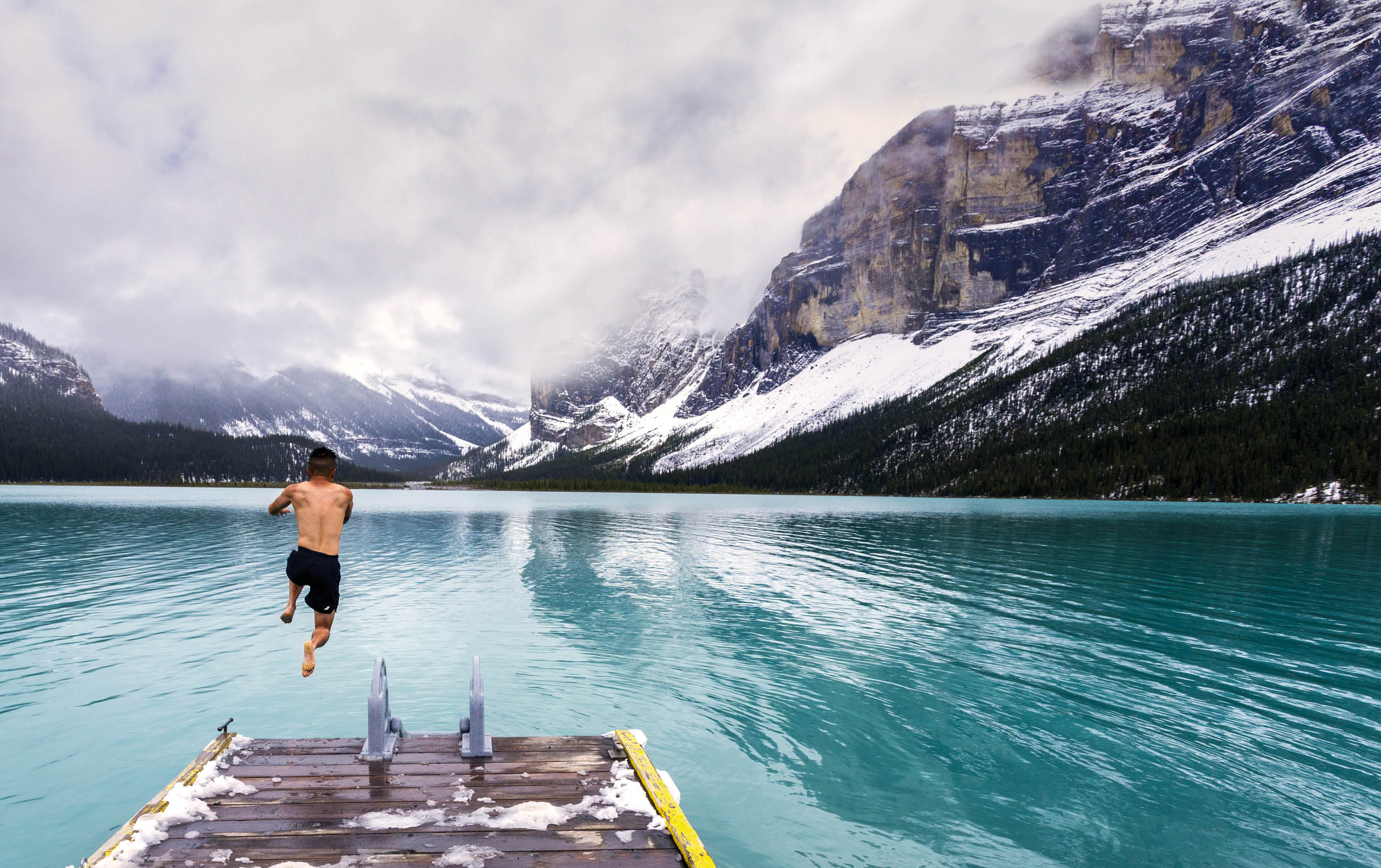Bold jump into the cold waters of Maligne Lake in Jasper National Park